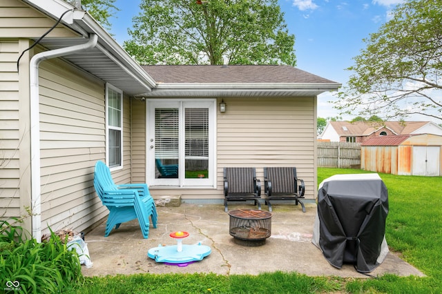 view of patio / terrace with a fire pit, a shed, an outdoor structure, and area for grilling