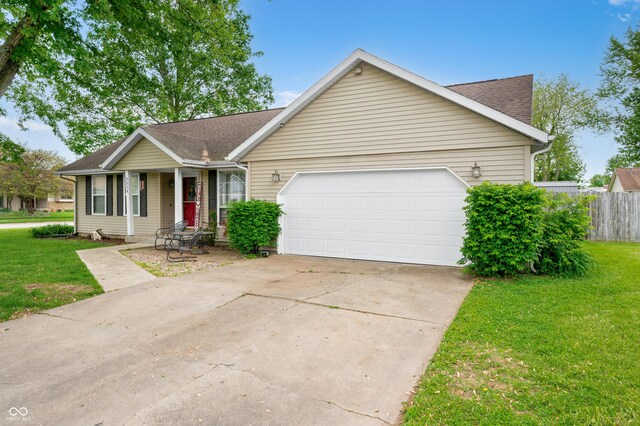 ranch-style home with a garage, roof with shingles, concrete driveway, and covered porch