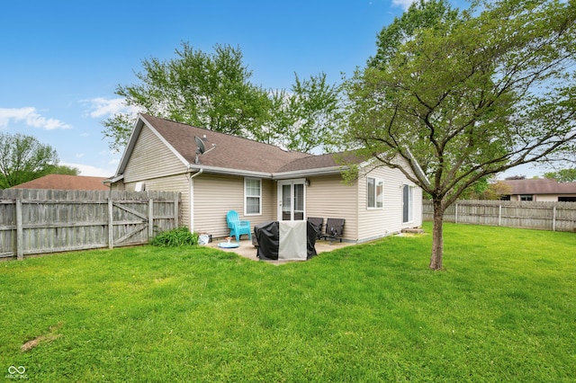 rear view of house featuring a patio and a shingled roof