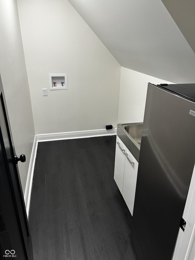 laundry area with cabinet space, dark wood-style floors, washer hookup, and baseboards
