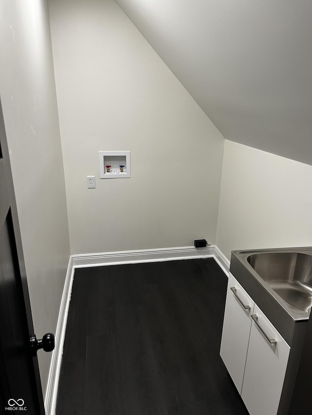 laundry room featuring washer hookup, wood finished floors, and baseboards