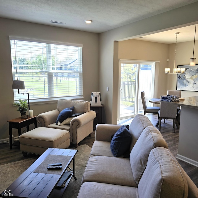 6403 Yuma Ct, Whitestown, IN 46075 - living room with healthy amount of natural light, a chandelier, wood finished floors, and baseboards