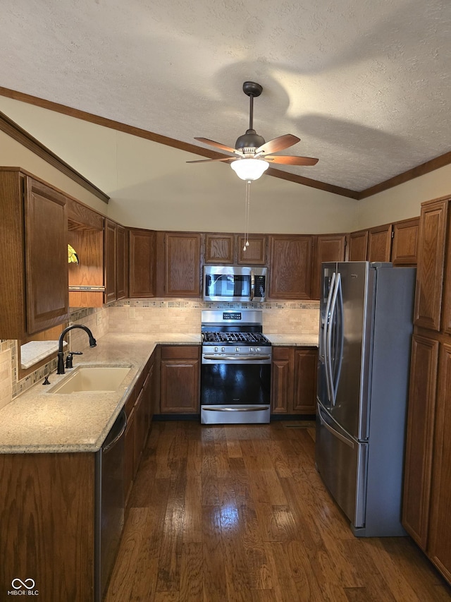 8055 Foxchase Dr, Indianapolis, IN 46256 - kitchen featuring stainless steel appliances, vaulted ceiling, ceiling fan, dark wood-type flooring, and decorative backsplash