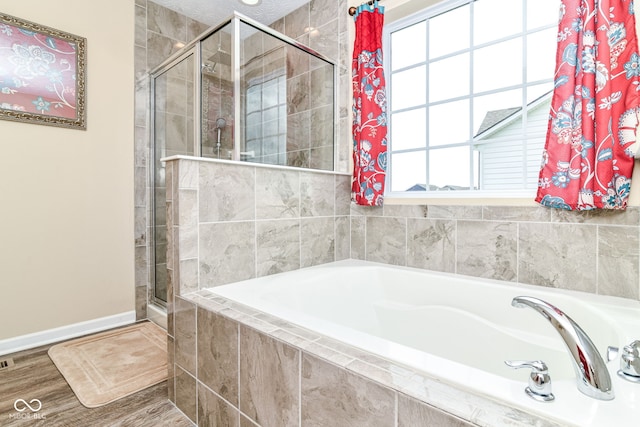 9860 Gallop Ln, Fishers, IN 46040 - bathroom with a shower stall, a bath, and wood finished floors
