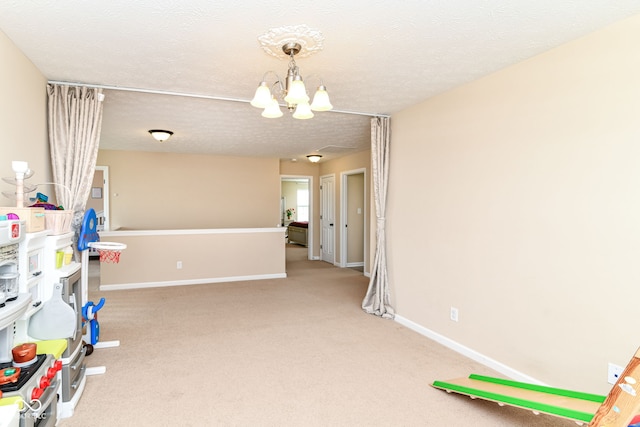 9860 Gallop Ln, Fishers, IN 46040 - recreation room with a chandelier, carpet floors, and a textured ceiling