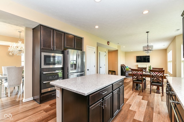 9860 Gallop Ln, Fishers, IN 46040 - kitchen featuring stainless steel appliances, a chandelier, light wood-style flooring, hanging light fixtures, and recessed lighting