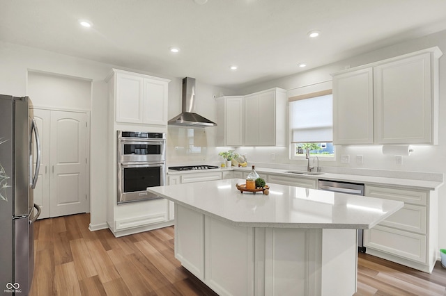 5366 Laurel Crest Run, Noblesville, IN 46062 - kitchen with wall chimney range hood, appliances with stainless steel finishes, a sink, white cabinetry, and light countertops