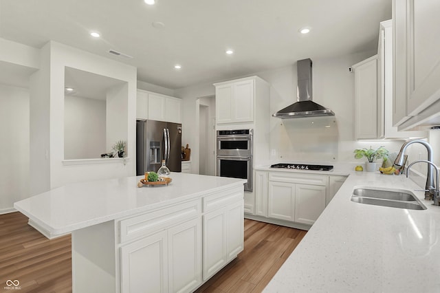 5366 Laurel Crest Run, Noblesville, IN 46062 - kitchen with appliances with stainless steel finishes, wall chimney range hood, a sink, light wood-style floors, and a center island
