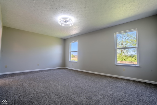 6491 Enclave Blvd, Greenwood, IN 46143 - spare room with dark carpet, a textured ceiling, and baseboards
