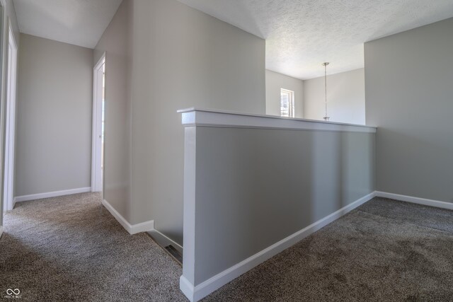 6491 Enclave Blvd, Greenwood, IN 46143 - corridor featuring carpet floors, baseboards, an upstairs landing, and a textured ceiling