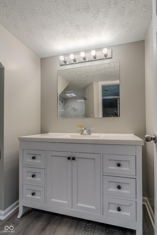 6491 Enclave Blvd, Greenwood, IN 46143 - bathroom with wood finished floors, vanity, baseboards, and a textured ceiling