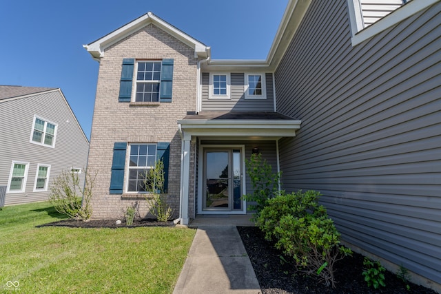 6491 Enclave Blvd, Greenwood, IN 46143 - view of exterior entry featuring brick siding and a yard
