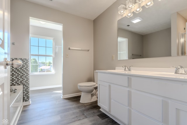 6491 Enclave Blvd, Greenwood, IN 46143 - full bath with wood finished floors, toilet, a bathtub, baseboards, and double vanity