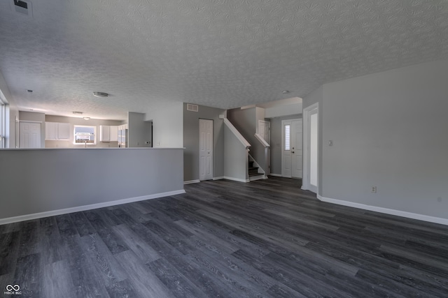 6491 Enclave Blvd, Greenwood, IN 46143 - unfurnished living room featuring a textured ceiling, dark wood-style flooring, healthy amount of natural light, baseboards, and stairs