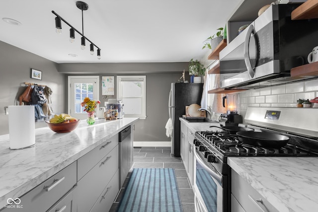 2336 Sycamore St, Columbus, IN 47201 - kitchen featuring appliances with stainless steel finishes, open shelves, tasteful backsplash, and dark tile patterned flooring