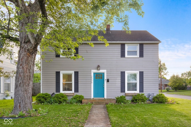 2336 Sycamore St, Columbus, IN 47201 - colonial inspired home featuring a chimney and a front lawn