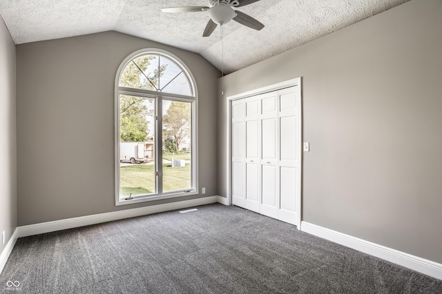 51 Glasgow Ln, Noblesville, IN 46060 - unfurnished bedroom with a textured ceiling, lofted ceiling, carpet flooring, baseboards, and a closet