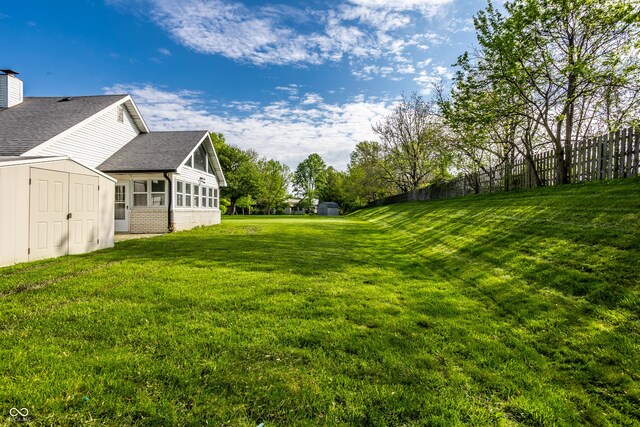 51 Glasgow Ln, Noblesville, IN 46060 - view of grassy yard with a storage unit, an outdoor structure, and a sunroom
