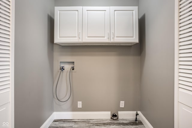 51 Glasgow Ln, Noblesville, IN 46060 - laundry area featuring washer hookup, cabinet space, wood finished floors, and baseboards