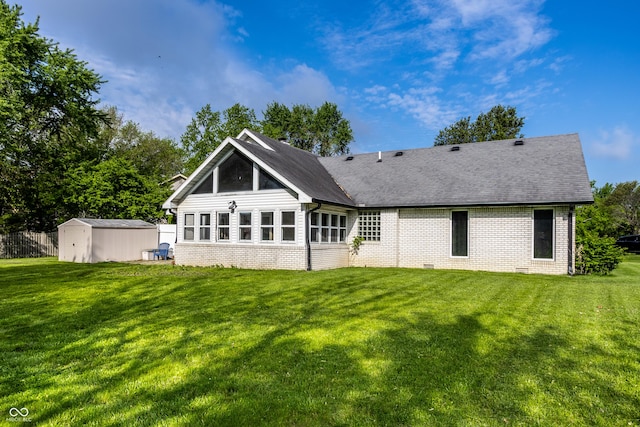 51 Glasgow Ln, Noblesville, IN 46060 - back of property with brick siding, a storage shed, a lawn, and an outbuilding