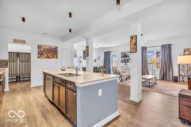 5256 Bramwell Ln, Whitestown, IN 46075 - kitchen with a sink, light wood finished floors, light countertops, an island with sink, and dishwasher