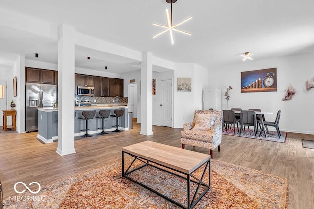 5256 Bramwell Ln, Whitestown, IN 46075 - living area featuring light wood-style floors and baseboards