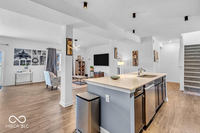 5256 Bramwell Ln, Whitestown, IN 46075 - kitchen featuring open floor plan, a sink, light wood-style flooring, light countertops, and an island with sink