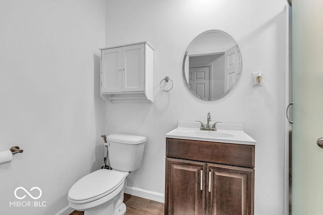 5256 Bramwell Ln, Whitestown, IN 46075 - bathroom with baseboards, toilet, vanity, and wood finished floors