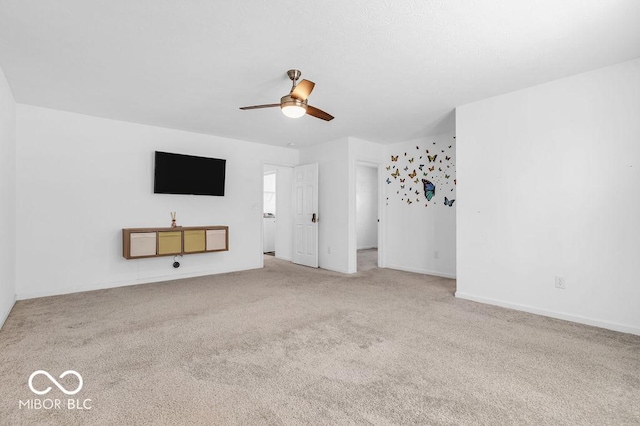 5256 Bramwell Ln, Whitestown, IN 46075 - unfurnished living room featuring a ceiling fan, carpet floors, and baseboards