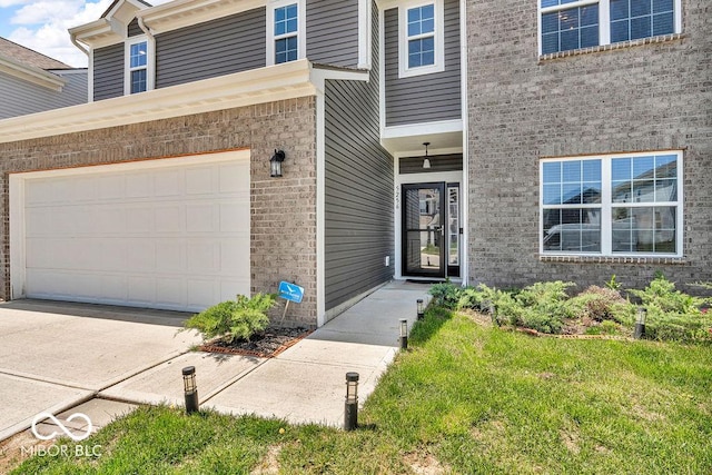 5256 Bramwell Ln, Whitestown, IN 46075 - property entrance with driveway, an attached garage, and brick siding