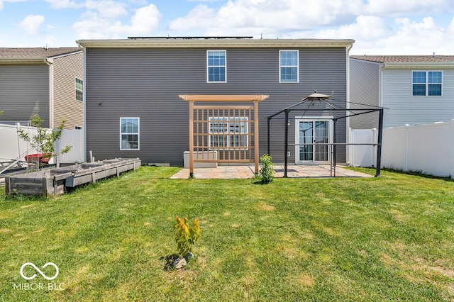 5256 Bramwell Ln, Whitestown, IN 46075 - back of property featuring a gazebo, a patio area, and a vegetable garden