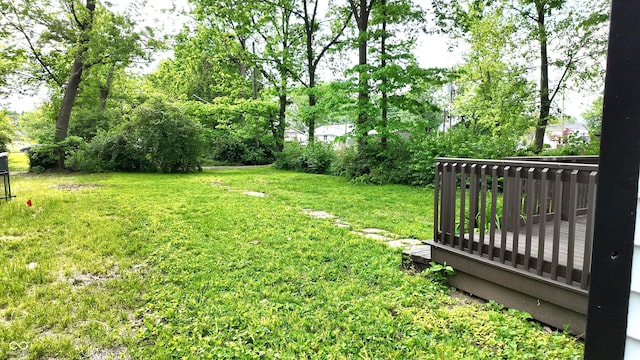 1148 N Pershing Ave, Indianapolis, IN 46222 - view of grassy yard with a wooden deck and view of scattered trees