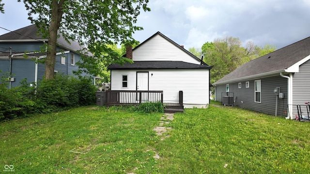 1148 N Pershing Ave, Indianapolis, IN 46222 - back of house with a wooden deck, a lawn, and a chimney