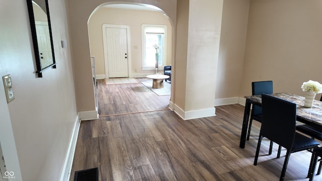 1148 N Pershing Ave, Indianapolis, IN 46222 - dining space featuring arched walkways, wood finished floors, and baseboards