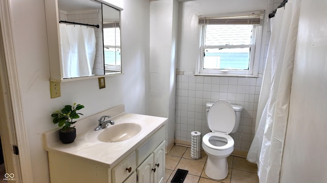 1148 N Pershing Ave, Indianapolis, IN 46222 - full bathroom featuring tile patterned floors, tile walls, vanity, and toilet