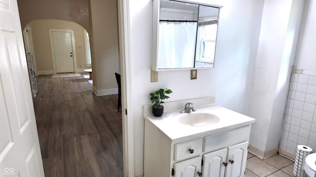 1148 N Pershing Ave, Indianapolis, IN 46222 - full bathroom featuring vanity, tile walls, and wood finished floors