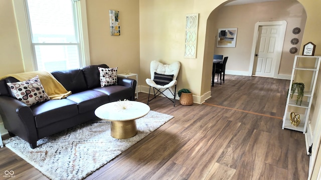 1148 N Pershing Ave, Indianapolis, IN 46222 - living area featuring arched walkways, wood finished floors, and baseboards
