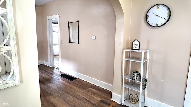 1148 N Pershing Ave, Indianapolis, IN 46222 - hall featuring arched walkways, baseboards, and dark wood-type flooring