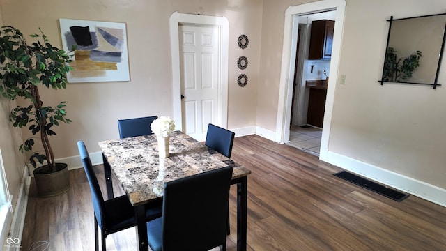 1148 N Pershing Ave, Indianapolis, IN 46222 - dining area featuring baseboards and dark wood-type flooring