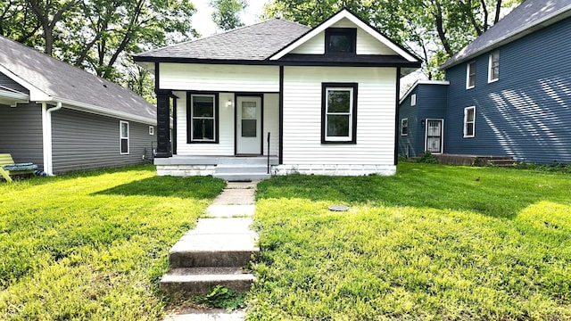 1148 N Pershing Ave, Indianapolis, IN 46222 - view of front of home with covered porch, a front lawn, and a shingled roof