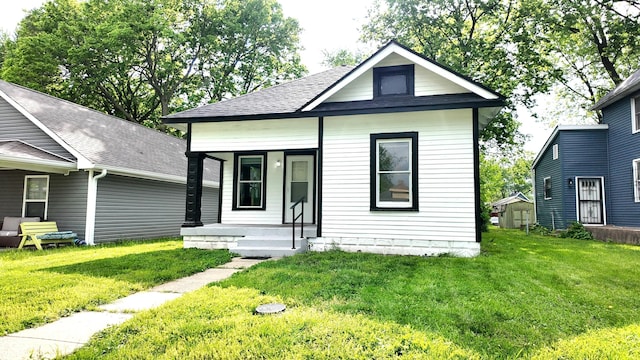 1148 N Pershing Ave, Indianapolis, IN 46222 - view of front of home featuring covered porch, a front yard, and roof with shingles