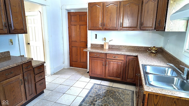 1148 N Pershing Ave, Indianapolis, IN 46222 - kitchen featuring a sink, light tile patterned flooring, wall chimney exhaust hood, and dark countertops