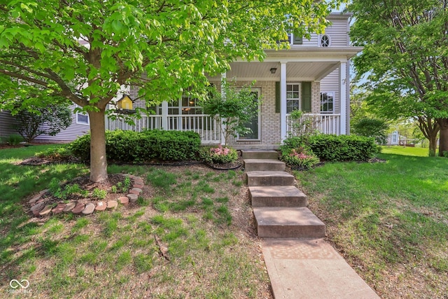 13063 E 131st St, Fishers, IN 46037 - view of front facade with covered porch, brick siding, and a front yard