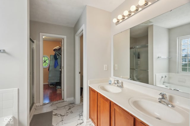 13063 E 131st St, Fishers, IN 46037 - bathroom featuring marble look tile flooring, a stall shower, a garden tub, double vanity, and a walk in closet
