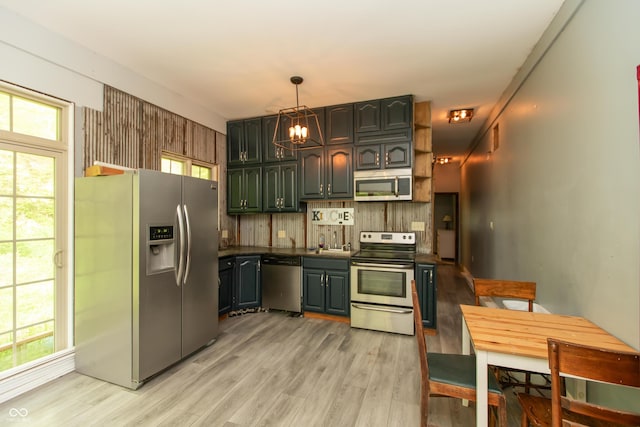 7730 Bear Creek Rd, Morgantown, IN 46160 - kitchen with appliances with stainless steel finishes, dark countertops, light wood-style flooring, decorative light fixtures, and a chandelier