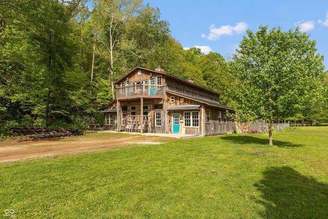 7730 Bear Creek Rd, Morgantown, IN 46160 - rear view of property featuring a yard, a chimney, and a wooded view