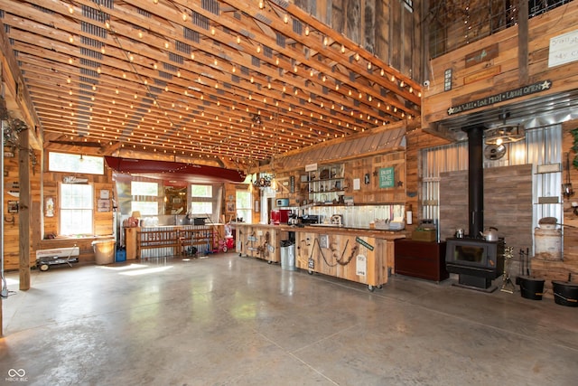 7730 Bear Creek Rd, Morgantown, IN 46160 - garage featuring wood walls, a wood stove, and a workshop area