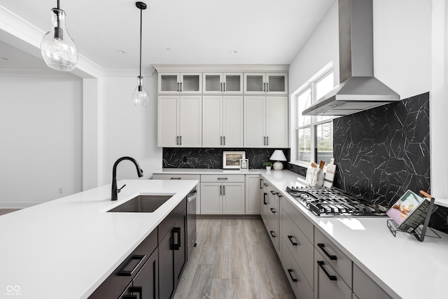 525 Fynn Pl, Indianapolis, IN 46202 - kitchen featuring a sink, wall chimney range hood, appliances with stainless steel finishes, and light countertops