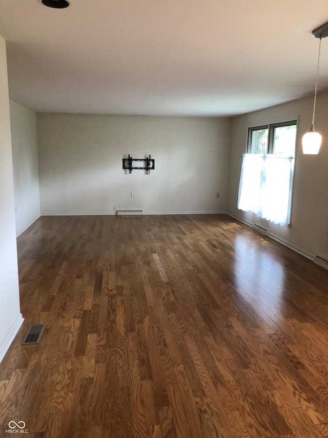 3619 31st St, Columbus, IN 47203 - spare room featuring dark wood-style flooring and baseboards