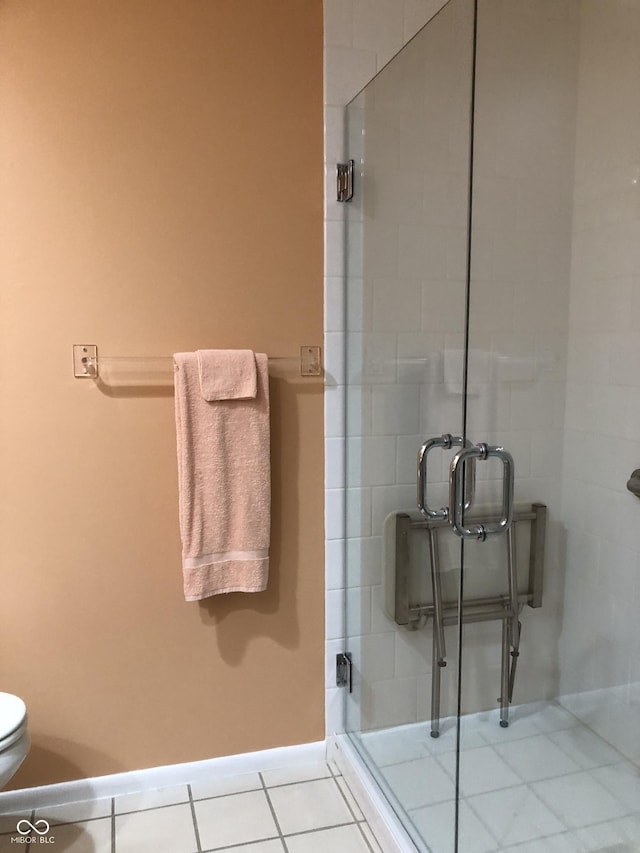 3619 31st St, Columbus, IN 47203 - full bathroom with a stall shower, baseboards, tile patterned floors, and toilet